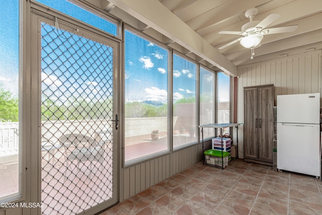 unfurnished sunroom with ceiling fan