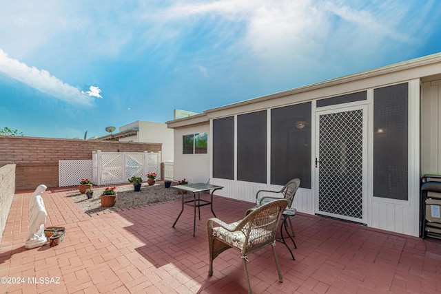 view of patio with a sunroom