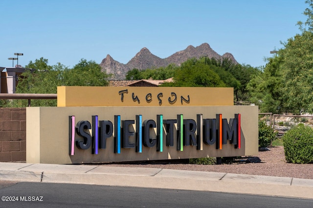 community sign with a mountain view