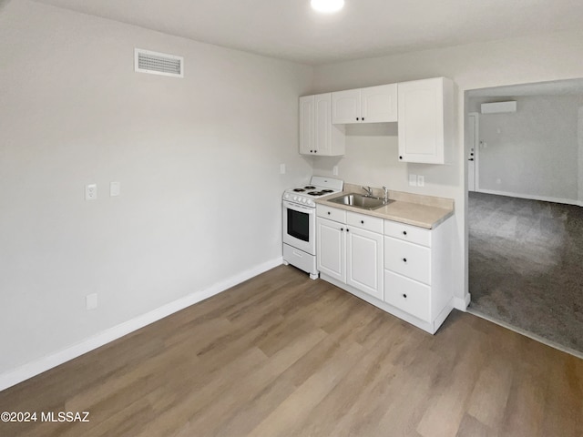 kitchen with sink, light hardwood / wood-style floors, white range oven, and white cabinets