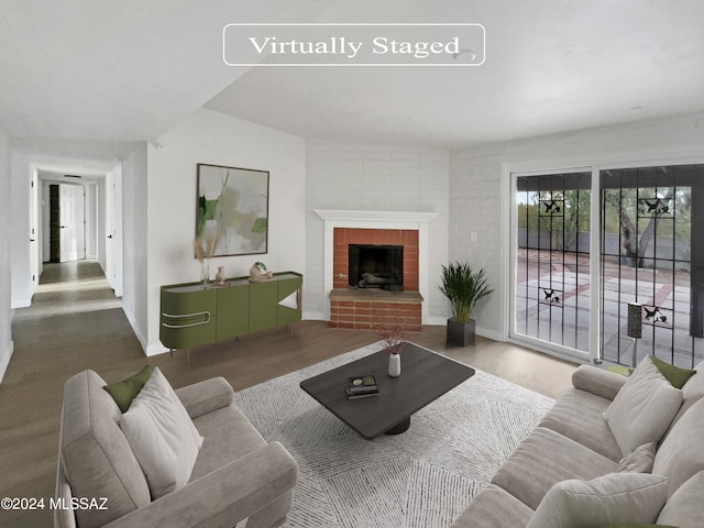 living room featuring wood-type flooring and a fireplace