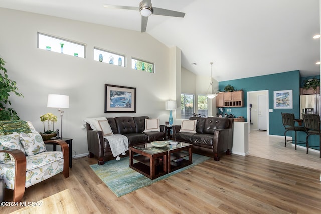 living room with light hardwood / wood-style floors, vaulted ceiling, and ceiling fan