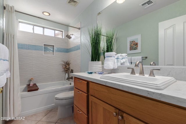 full bathroom with vanity, toilet, tiled shower / bath combo, and tile patterned flooring