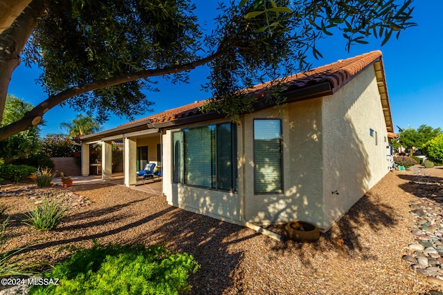 rear view of property featuring a patio