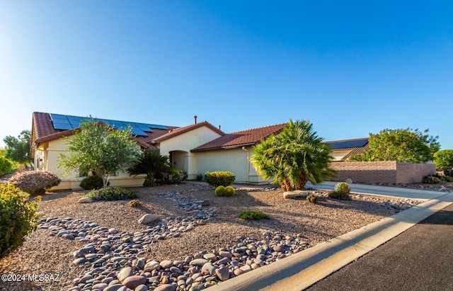 view of front of house featuring solar panels