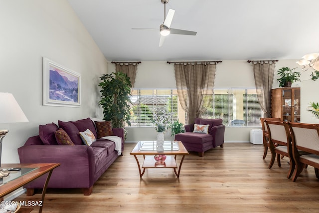 living room with light hardwood / wood-style floors and ceiling fan