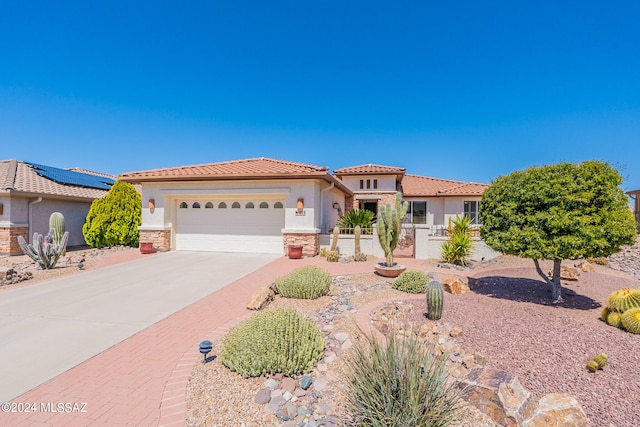 mediterranean / spanish-style home with a garage