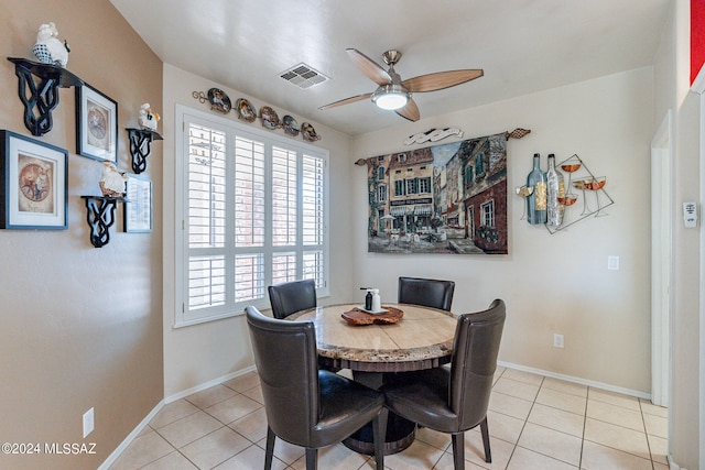 tiled dining area featuring ceiling fan