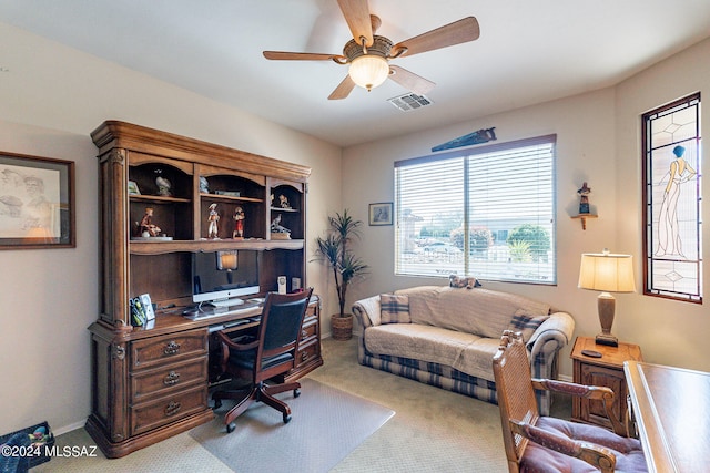 carpeted office space with ceiling fan