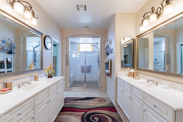 bathroom with vanity, a shower with shower door, and tile patterned floors