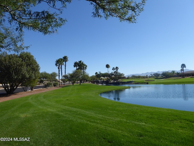 surrounding community featuring a water view and a yard