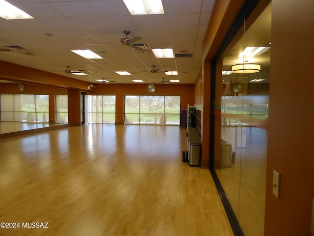 spare room with a paneled ceiling and wood-type flooring