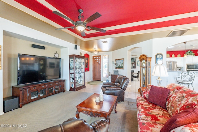 tiled living room with ceiling fan