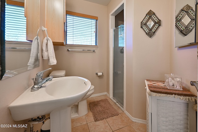 bathroom with a healthy amount of sunlight, an enclosed shower, toilet, and tile flooring