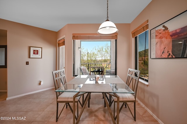 tiled dining space with a healthy amount of sunlight