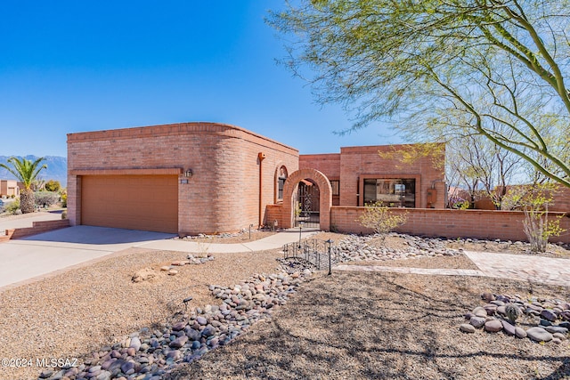 pueblo-style home with a garage