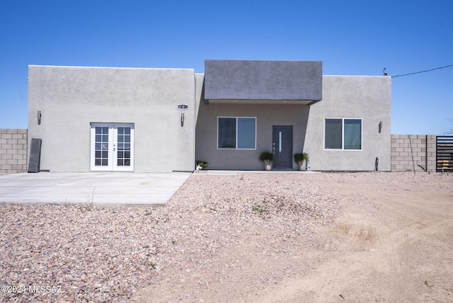 back of property with a patio area and french doors