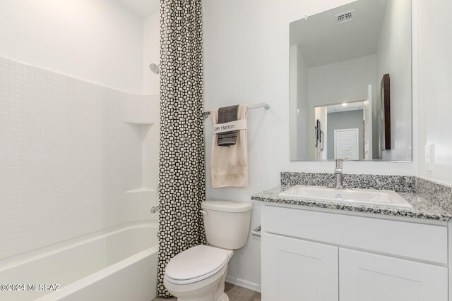 full bathroom featuring vanity, toilet, and washtub / shower combination