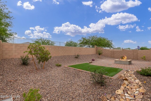 view of yard featuring a patio area and an outdoor fire pit