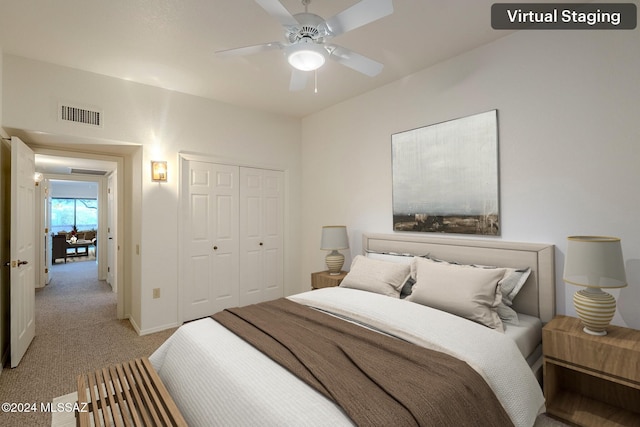 carpeted bedroom featuring ceiling fan and a closet