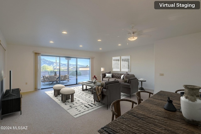 living room with ceiling fan and carpet floors