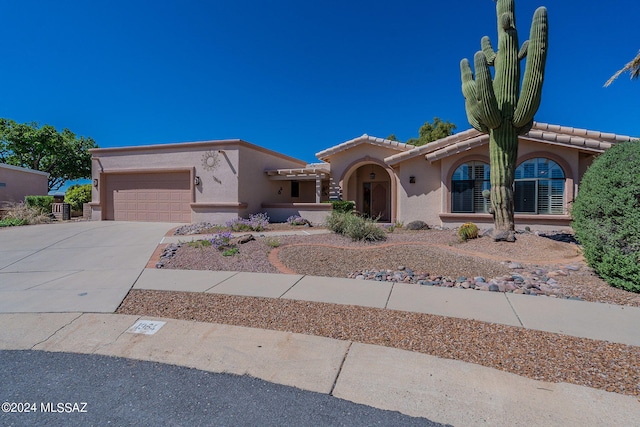 view of front of home with a garage and central AC