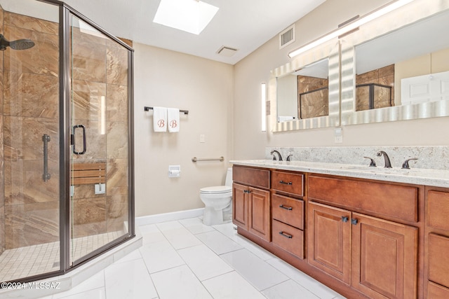 bathroom featuring toilet, an enclosed shower, vanity, and a skylight