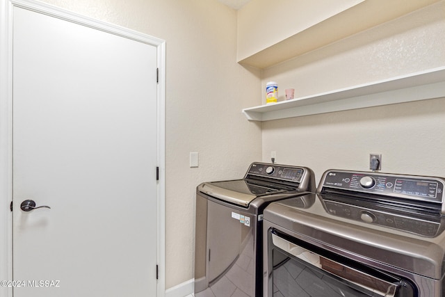 clothes washing area with washing machine and dryer