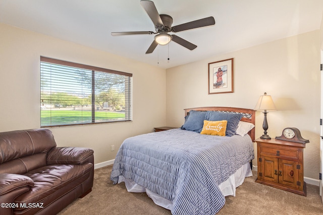 bedroom with ceiling fan and light carpet