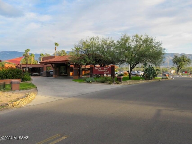 view of front of property with a mountain view and a carport