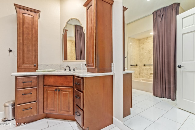 bathroom featuring a tub to relax in, vanity, and tile patterned floors