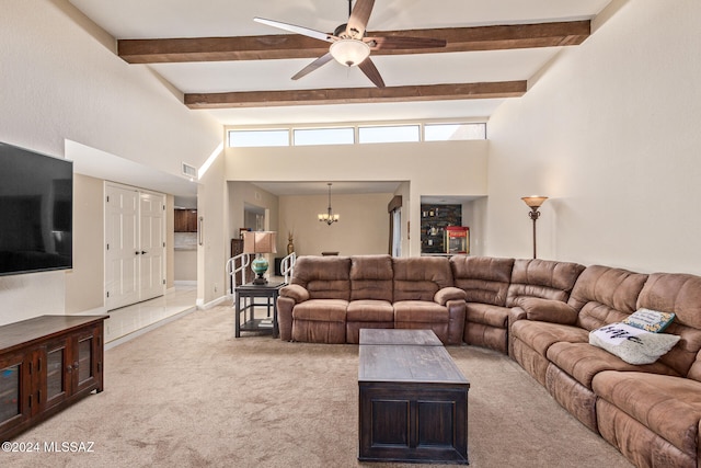 living room featuring beamed ceiling, light colored carpet, ceiling fan, and a towering ceiling