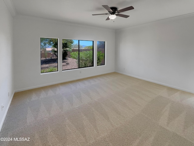 unfurnished room with light carpet, crown molding, and a healthy amount of sunlight