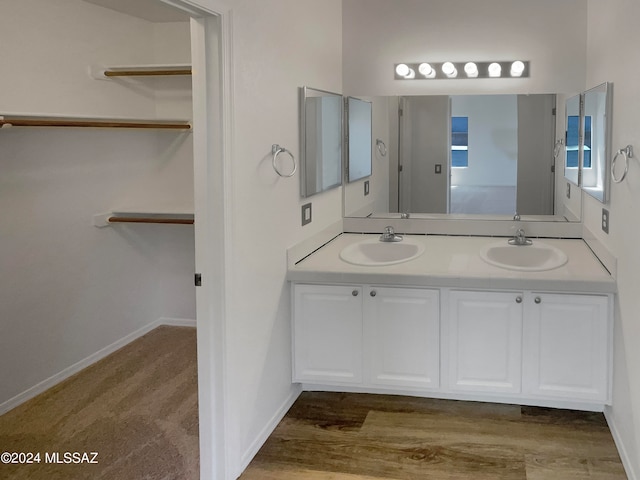 bathroom with wood-type flooring and double vanity