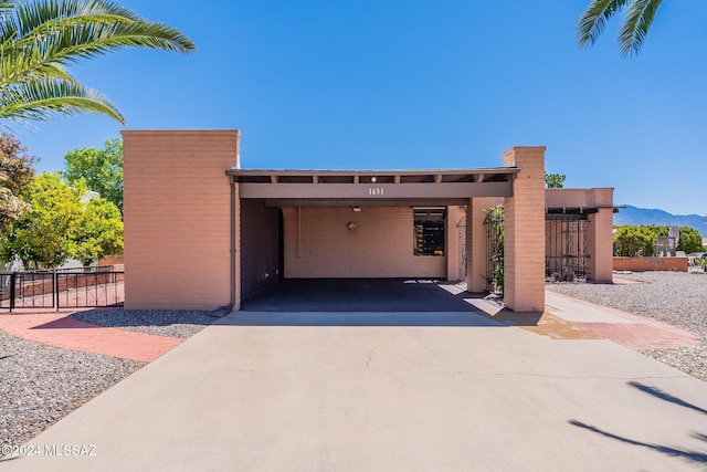 garage with fence and an attached carport