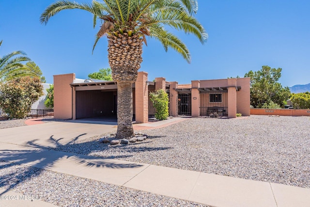 view of front of home with concrete driveway and fence