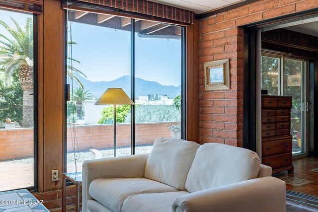 tiled dining area with ceiling fan and a raised ceiling