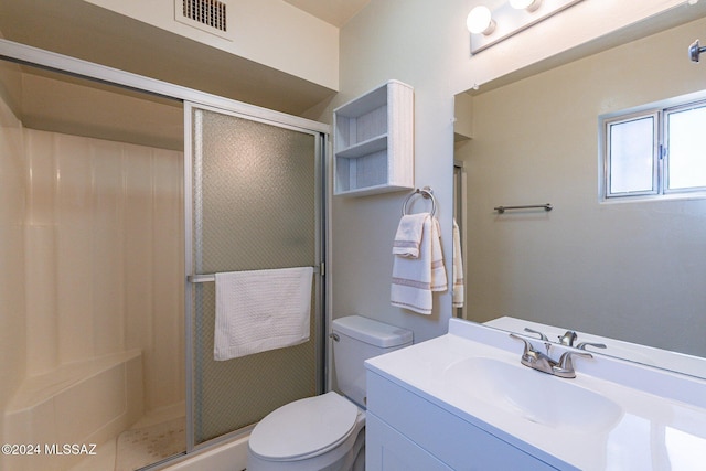 bathroom with toilet, a stall shower, visible vents, and vanity