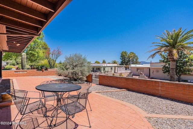 view of patio with outdoor dining area and fence