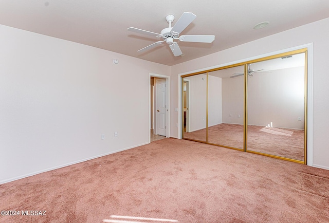 unfurnished bedroom featuring ceiling fan, a closet, visible vents, and carpet flooring