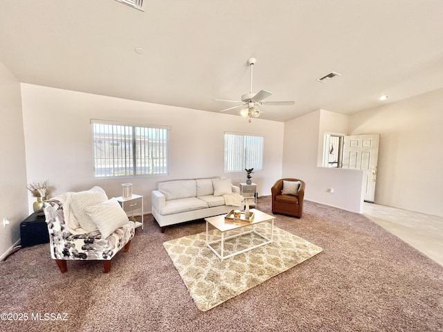 living room with vaulted ceiling, a wealth of natural light, carpet, and visible vents