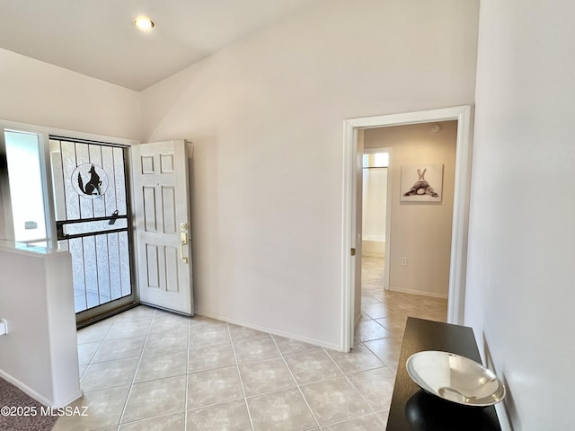 entryway featuring light tile patterned flooring and baseboards