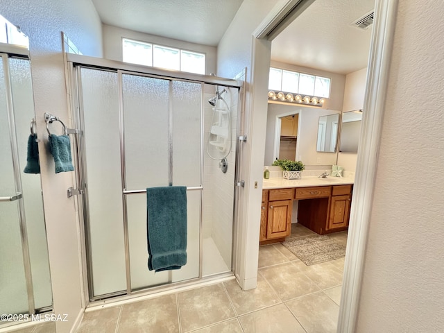 full bath with a stall shower, a wealth of natural light, and vanity