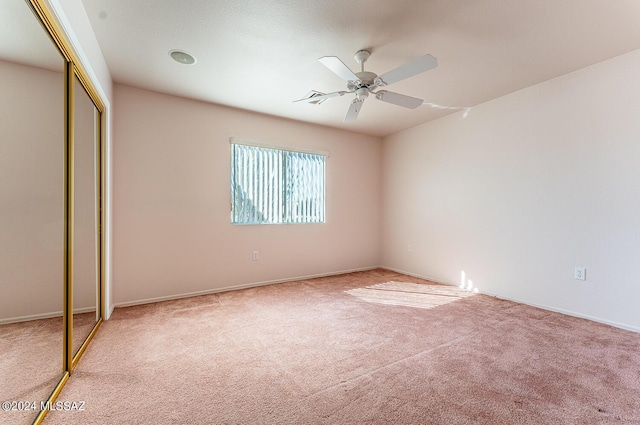 unfurnished bedroom with carpet, ceiling fan, and a closet