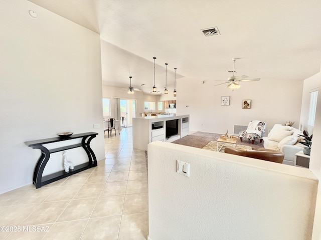 living room featuring light tile patterned floors, wine cooler, vaulted ceiling, and a ceiling fan