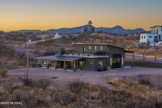 view of front of home featuring stucco siding and a mountain view