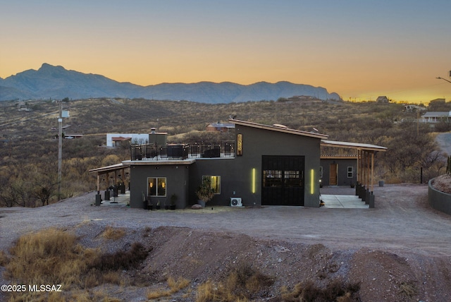 modern home with a mountain view and stucco siding