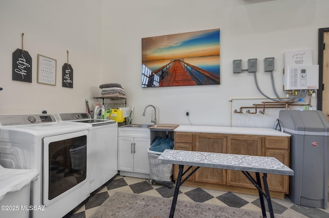 laundry area with cabinet space, dark floors, water heater, separate washer and dryer, and a sink