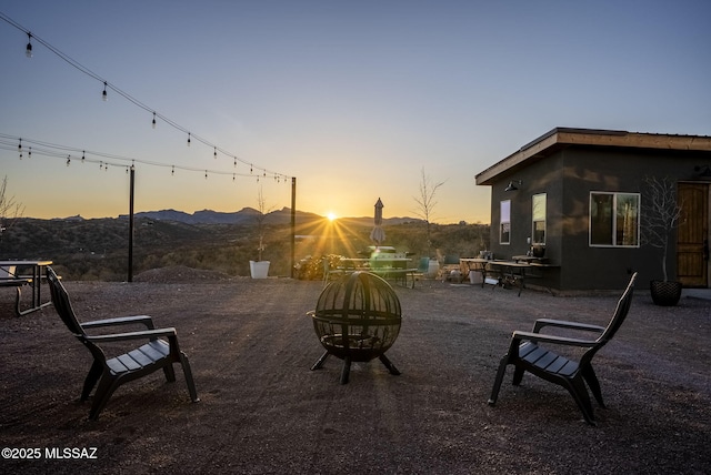 view of patio / terrace with an outdoor fire pit and a mountain view