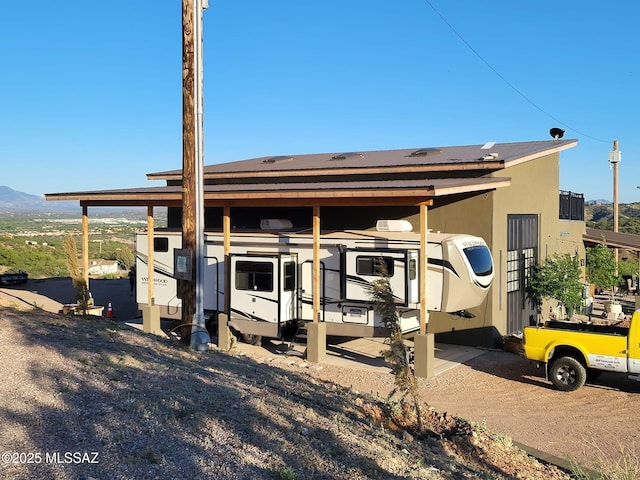 exterior space with stucco siding and a mountain view